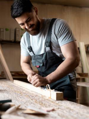 carpenter-cutting-mdf-board-inside-workshop